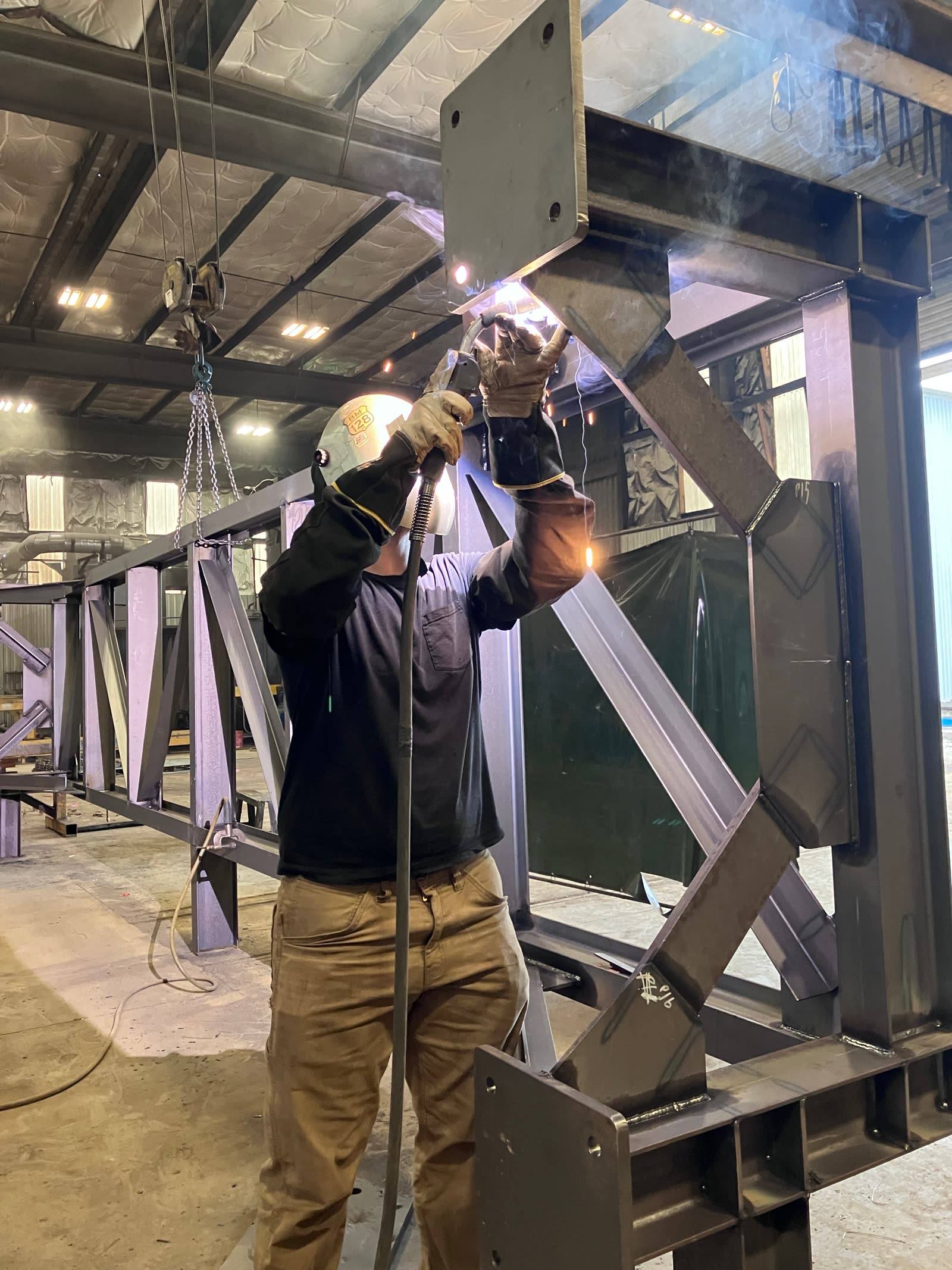 Welder working on a steel truss